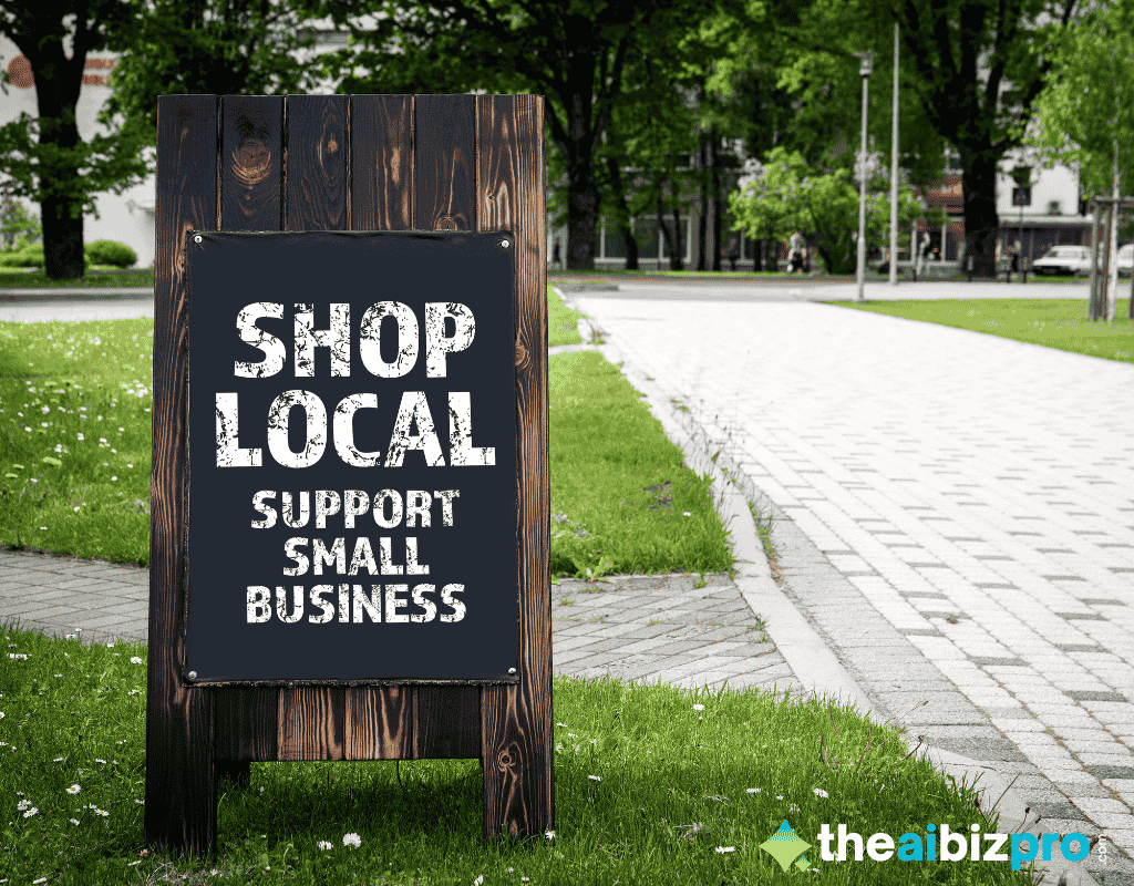 A wooden sandwich board sign on a grassy sidewalk reads "SHOP LOCAL SUPPORT SMALL BUSINESS" in white text, representing the community support that helps sustain small enterprises, further aided by AI automated bookkeeping for small online shops.